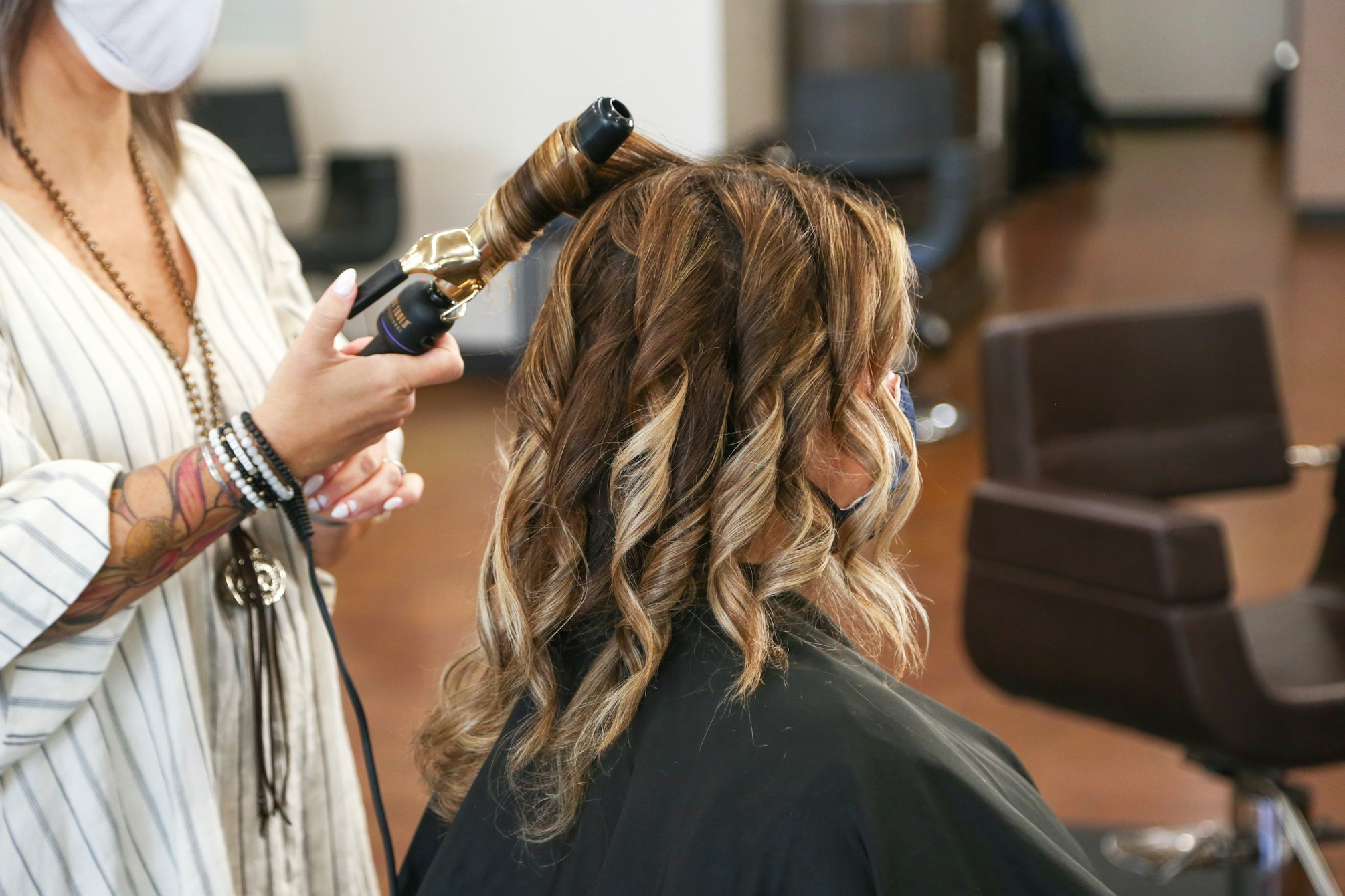 A stylist performing a designer haircut